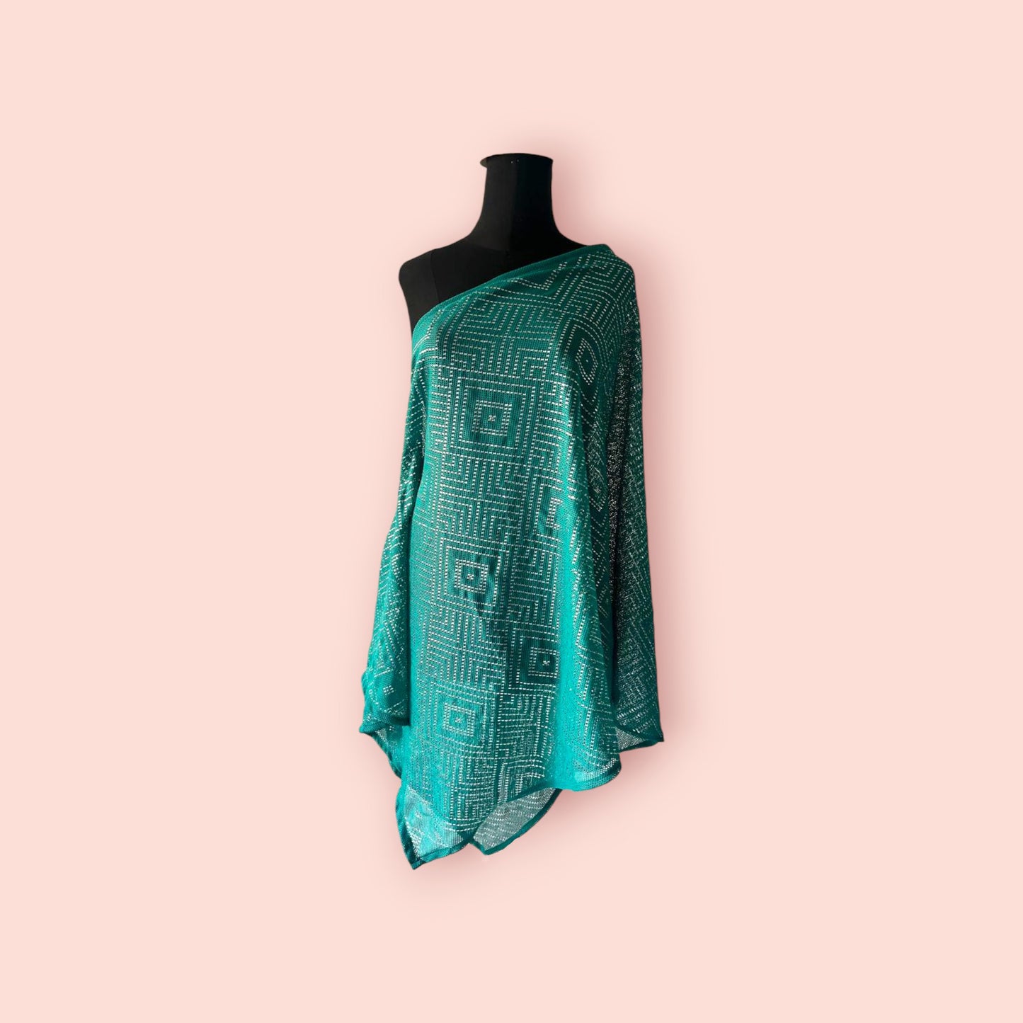 A teal knitted tally shawl