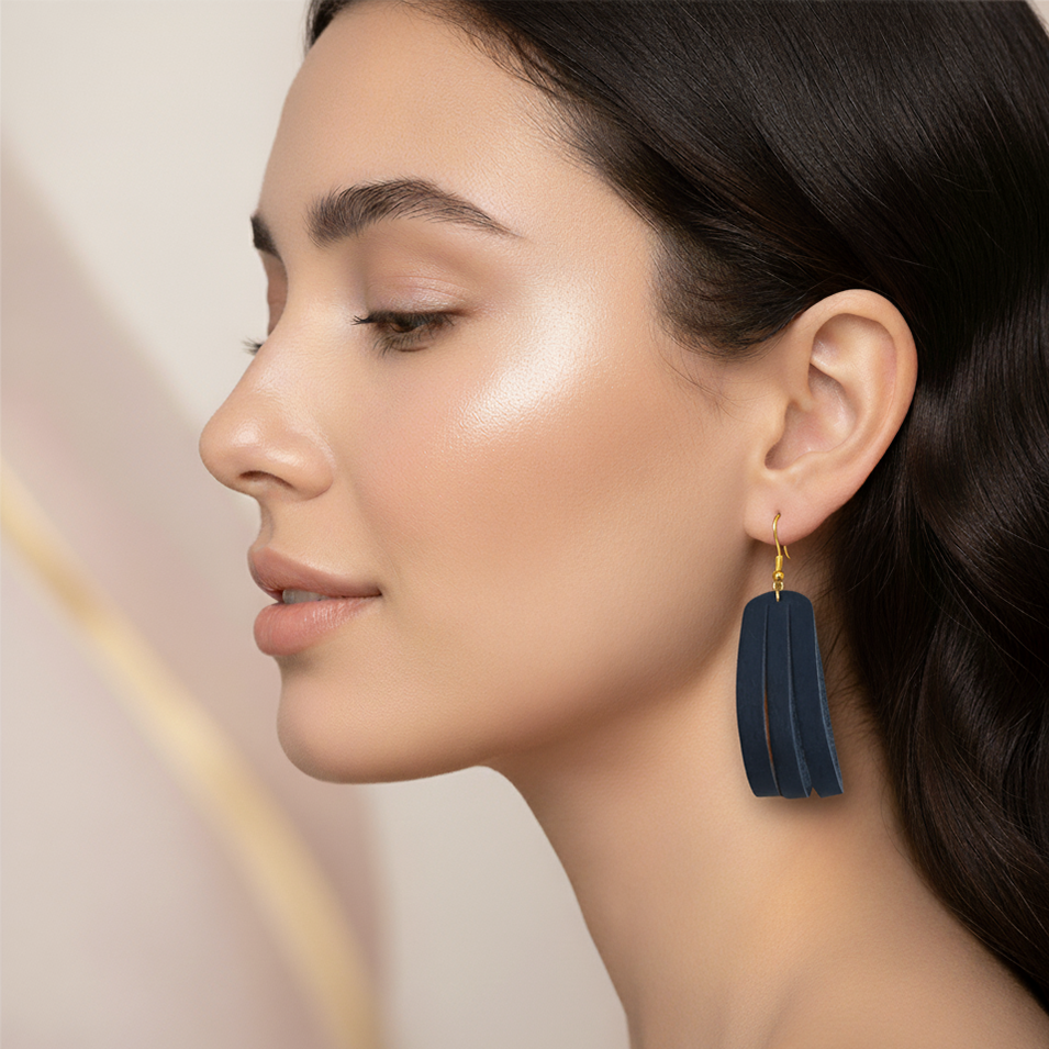 Woman wearing a Navy blue earring with a soft background