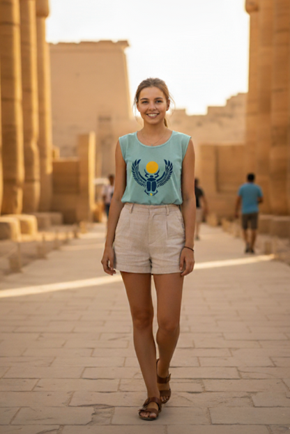 Woman in a blue sleeveless shirt with a design walking through an ancient temple.