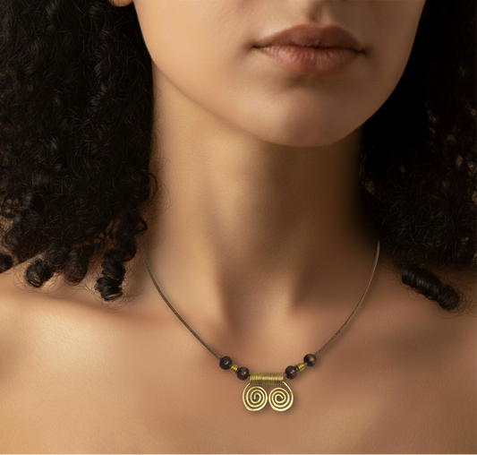 Necklace with a gold pendant on a model with dark hair