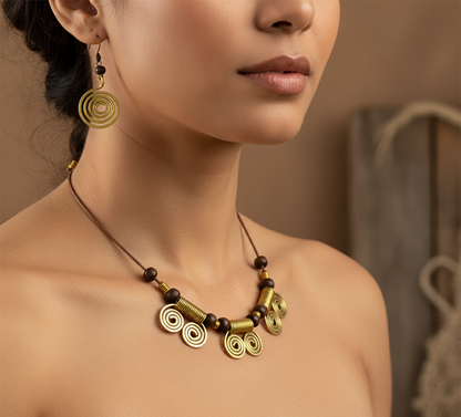 Close-up of a woman wearing an ornate gold and brown necklace and earrings against a neutral background.