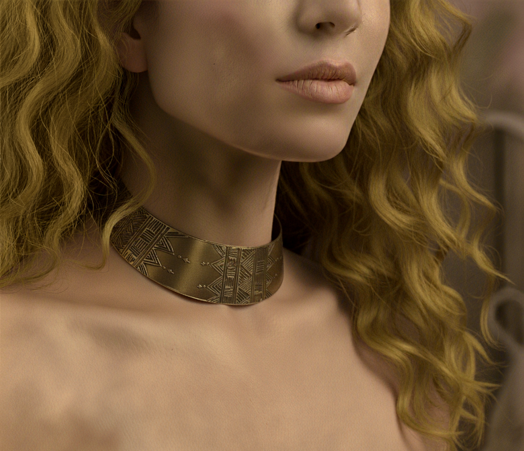 Close-up of a woman wearing a gold necklace with a blurred background