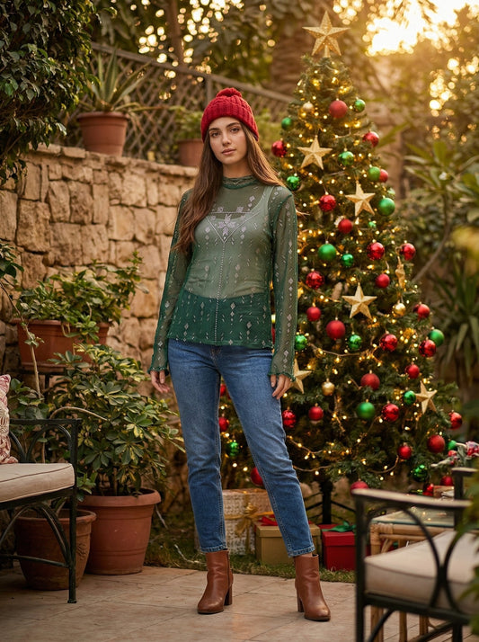 Woman standing in front of a decorated Christmas tree outdoors.
