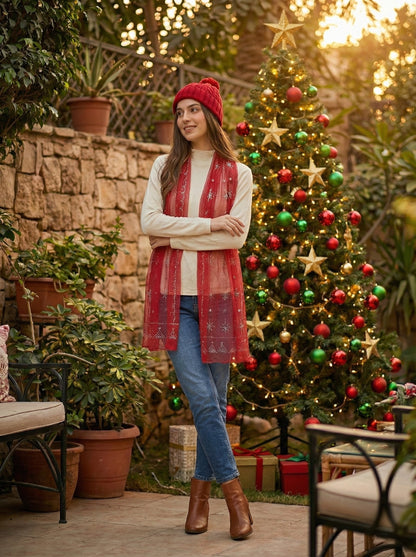 Woman standing in front of a decorated Christmas tree outdoors.