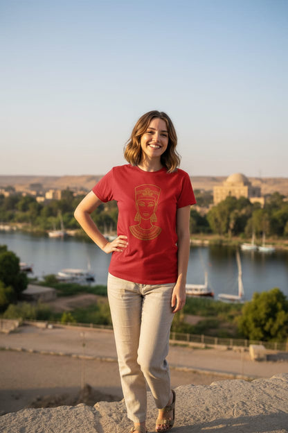 Woman in a red t-shirt standing outdoors with a scenic background
