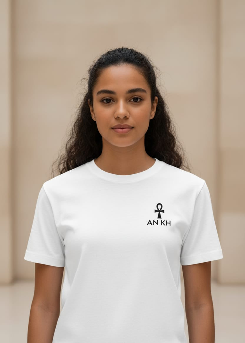 Person wearing a white t-shirt with an 'ANKH' logo on a beige background
