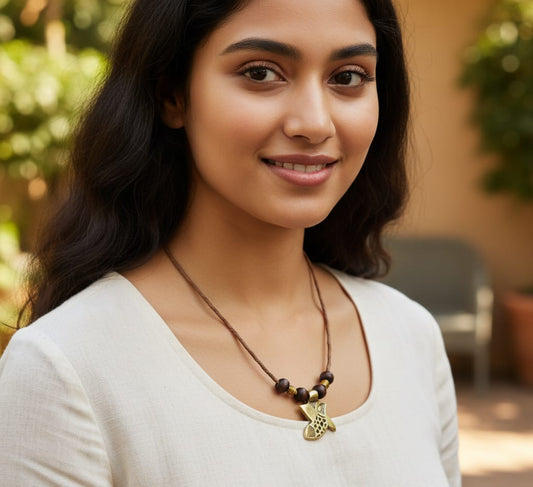 Woman wearing a necklace with a blurred outdoor background