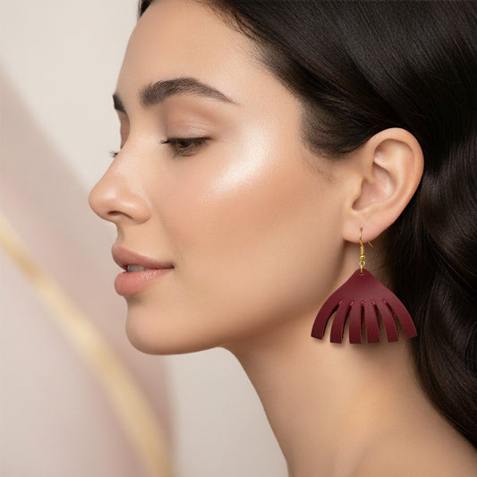Woman wearing a maroon earring with a blurred background