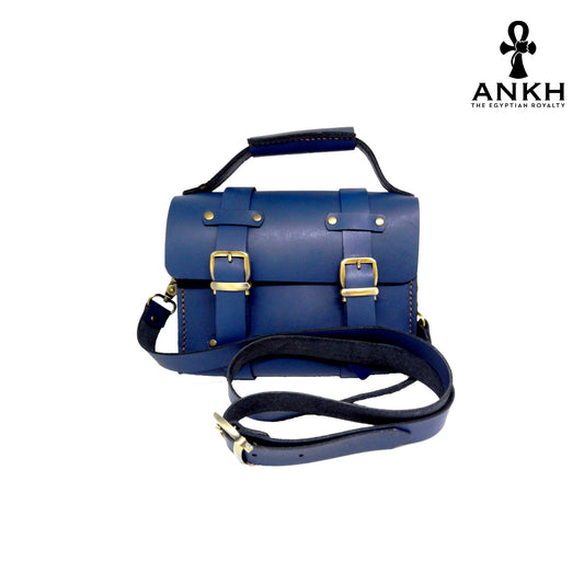 A genuine leather cross bag with handcrafted brass accessories and multiple pockets, displayed on a white background with a black logo of ANKH - The Egyptian Royalty.