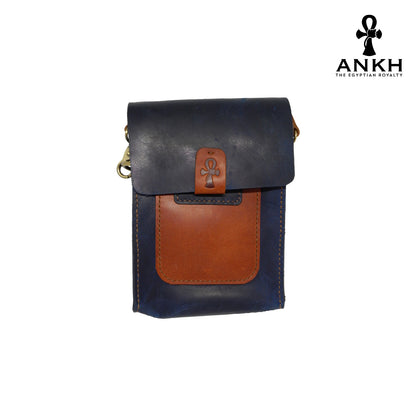 A genuine leather cross bag in navy blue and tan color with handcrafted brass accessories and multiple pockets, displayed on a white mannequin bust with a black logo of ANKH - The Egyptian Royalty.