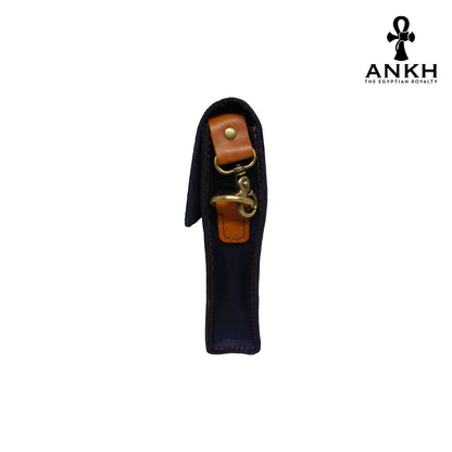 A genuine leather cross bag in navy blue and tan color with handcrafted brass accessories and multiple pockets, displayed on a white mannequin bust with a black logo of ANKH - The Egyptian Royalty.