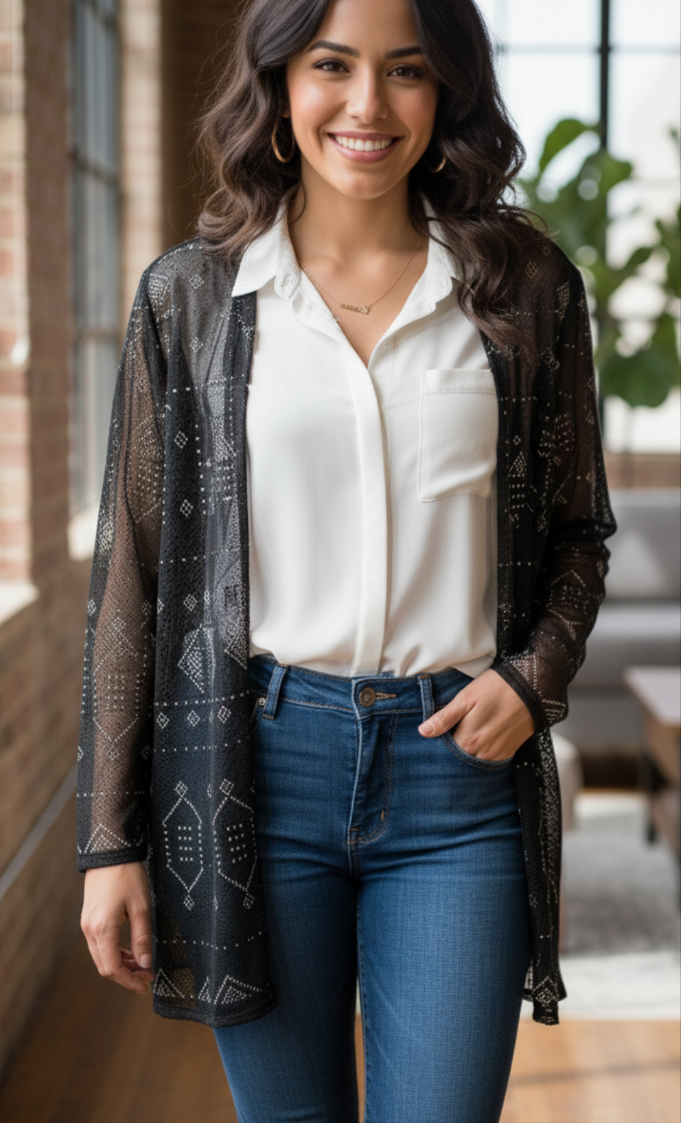 Woman standing in a modern living room wearing embroidered Tally jacket