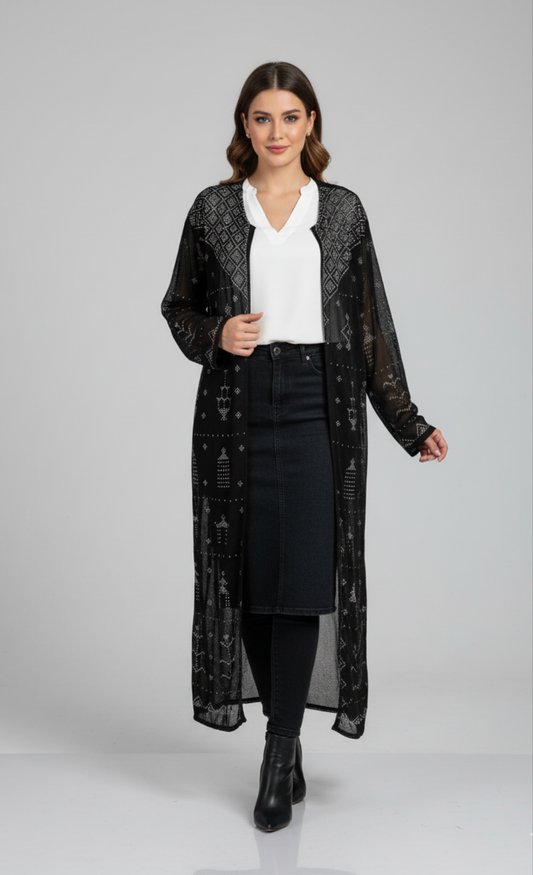 Woman wearing a black lace Tally tunic over a white blouse and black skirt on a gray background