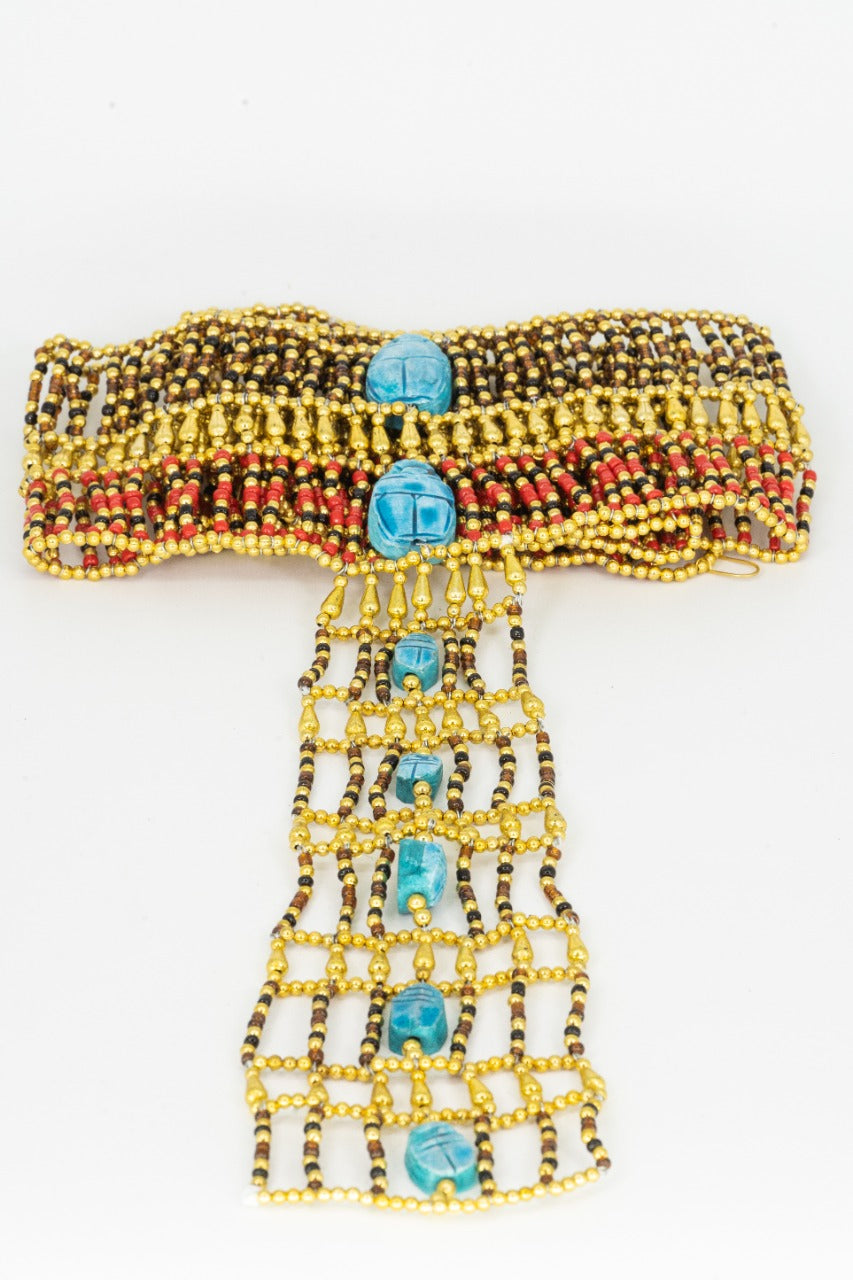 A luxurious beads strap adorned with radiant Egyptian Blue scarabs amidst golden and red beads; an epitome of ancient Egyptian elegance.