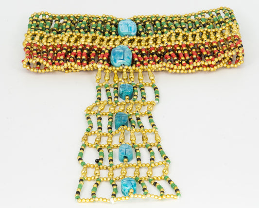  A luxurious beads strap adorned with radiant Egyptian Blue scarabs amidst golden and red beads; an epitome of ancient Egyptian elegance.