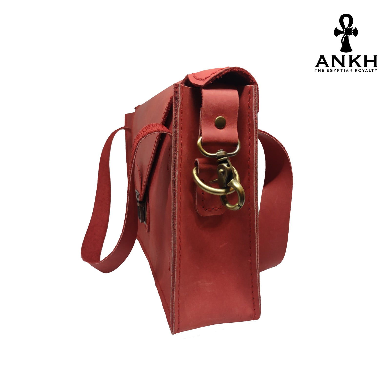 A genuine leather cross bag with handcrafted brass accessories and multiple pockets, displayed on a white background with a black logo of ANKH - The Egyptian Royalty.