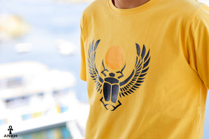 A man wearing a t-shirt with a printed Ancient Egyptian scarab symbol, made from soft 100% Egyptian cotton