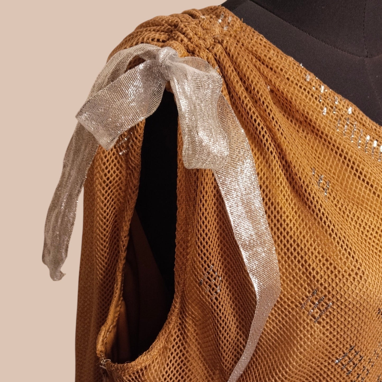 Brown textured tally fabric with a silver ribbon on a beige background