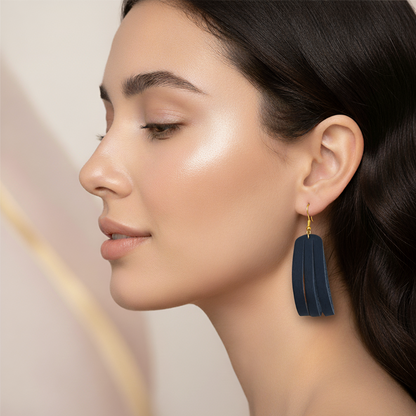 Woman wearing a Navy blue earring with a soft background