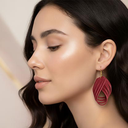 Woman wearing a red earring with a neutral background