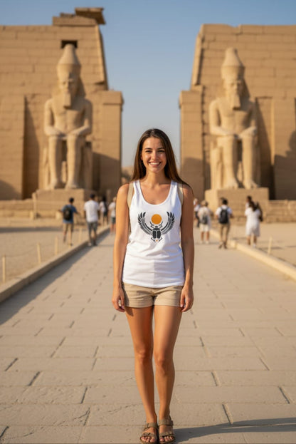 Woman standing in front of ancient temple statues with a clear blue sky.