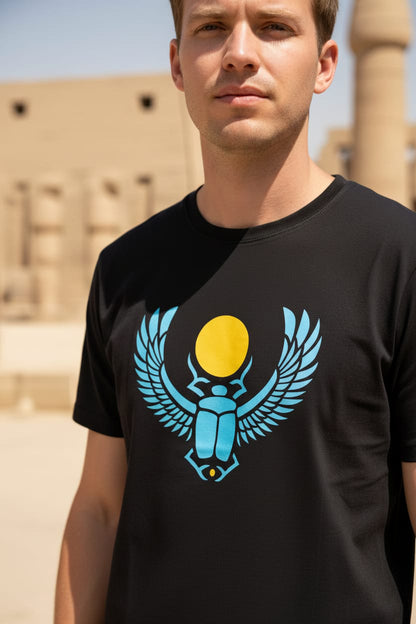 Man wearing a black t-shirt with a blue and yellow graphic design outdoors.