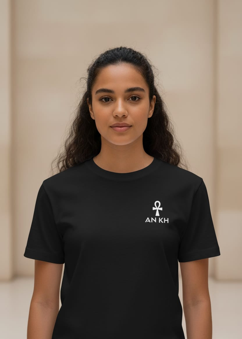 Person wearing a black t-shirt with a symbol and text on a beige background