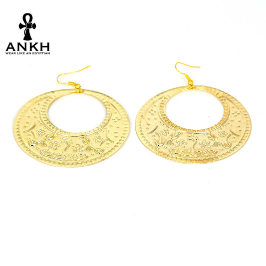 A pair of gold earrings with intricate engravings inspired by traditional Egyptian artistry, Egyptian accessory piece displayed with a black logo of ANKH