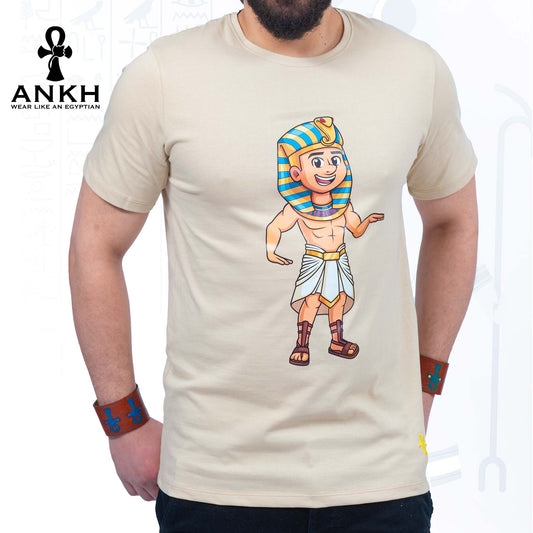 A man wearing an exclusive ‘Royal Tut’ T-shirt from Ankh featuring a playful cartoon depiction of King Tutankhamun printed on premium 100% Egyptian Cotton