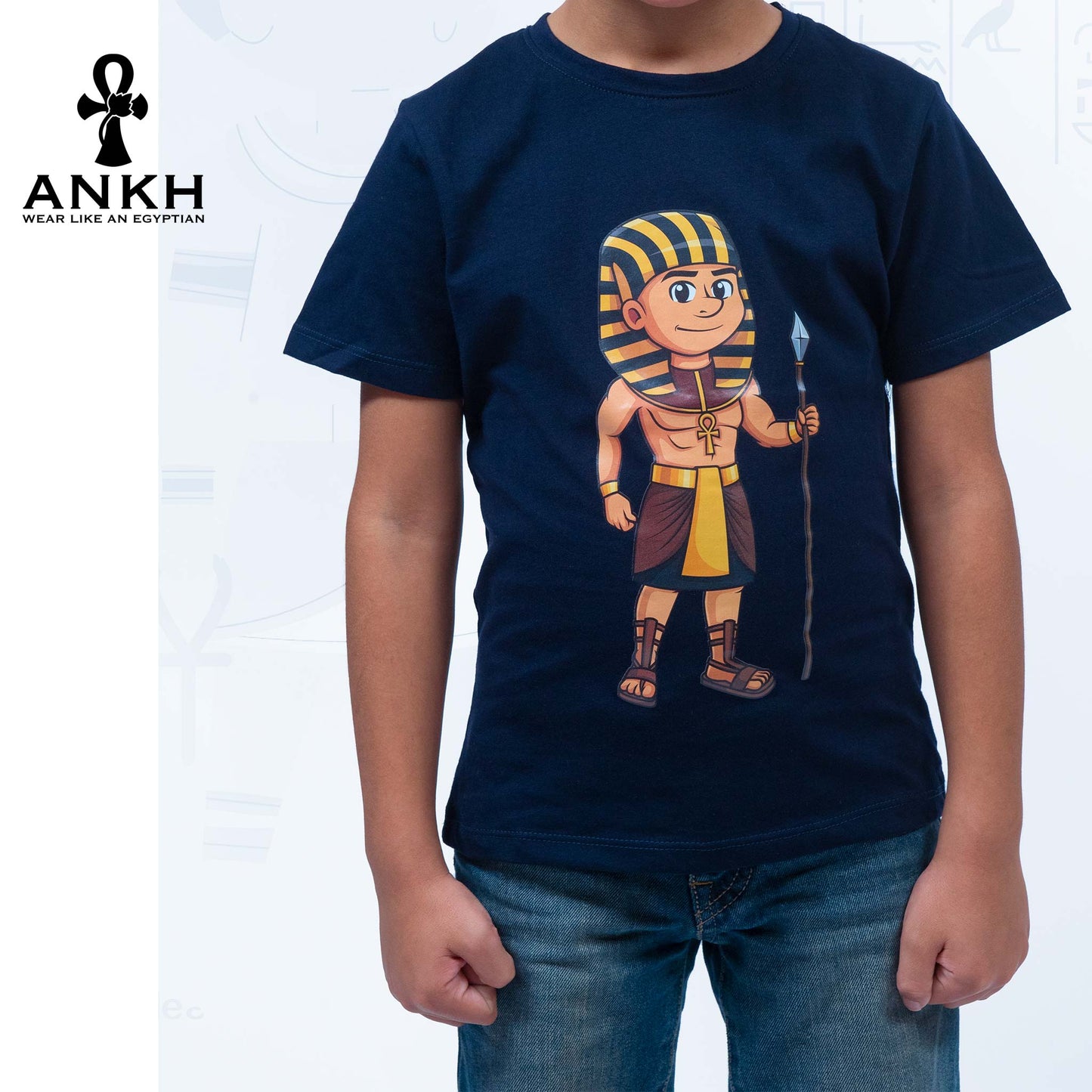 Child wearing a premium white t-shirt adorned with a colorful cartoon depiction of ancient Egyptian King Ahmose, made from luxurious Egyptian Cotton – available exclusively at Ankh