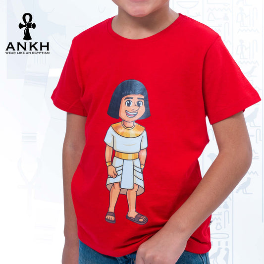 A child wearing a vibrant red T-shirt adorned with a playful illustration of Sinuhe, an iconic Egyptian boy character - an epitome of luxury and cultural richness