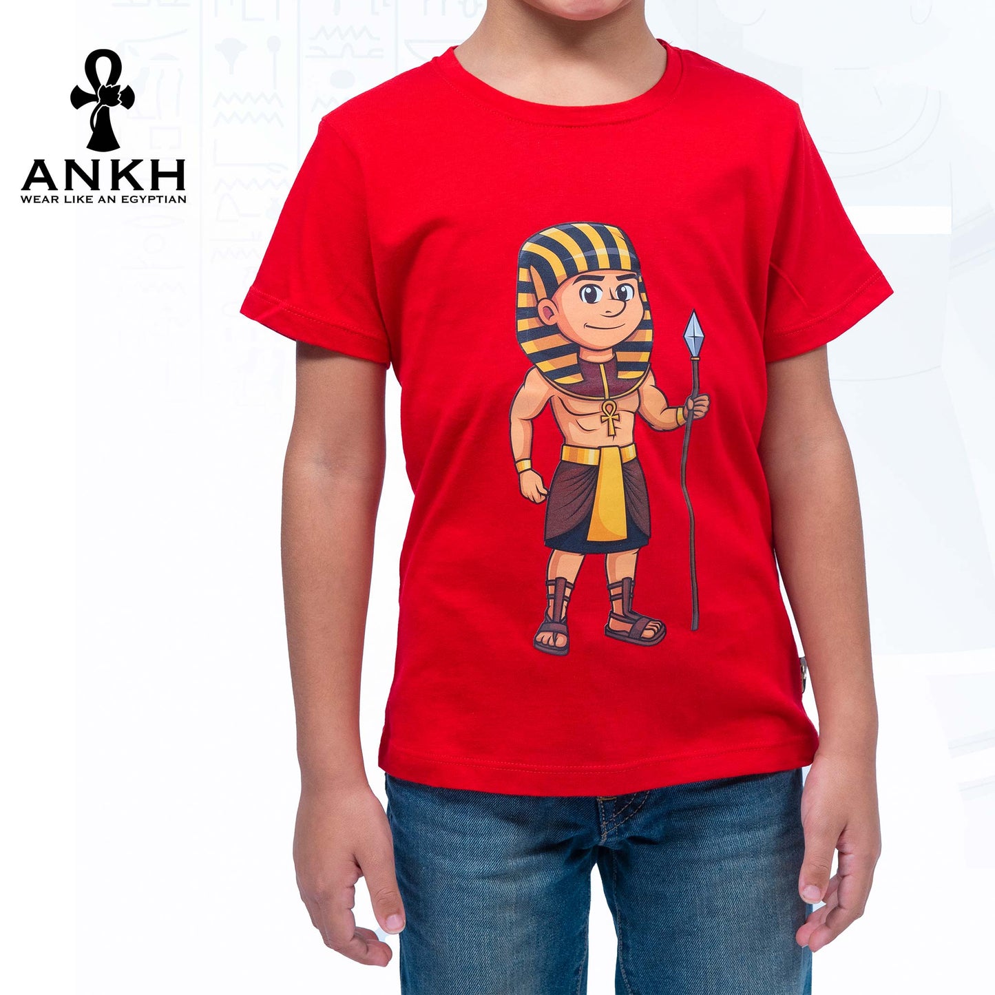 Child wearing a premium white t-shirt adorned with a colorful cartoon depiction of ancient Egyptian King Ahmose, made from luxurious Egyptian Cotton – available exclusively at Ankh