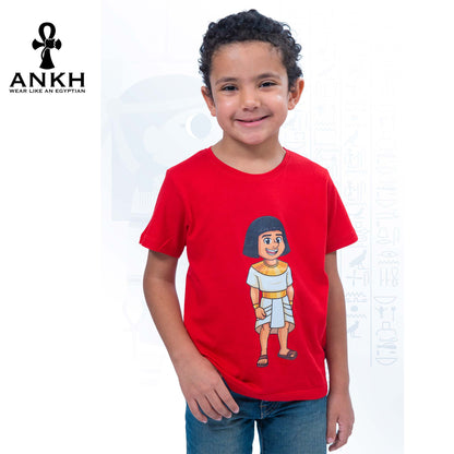 A child wearing a vibrant red T-shirt adorned with a playful illustration of Sinuhe, an iconic Egyptian boy character - an epitome of luxury and cultural richness