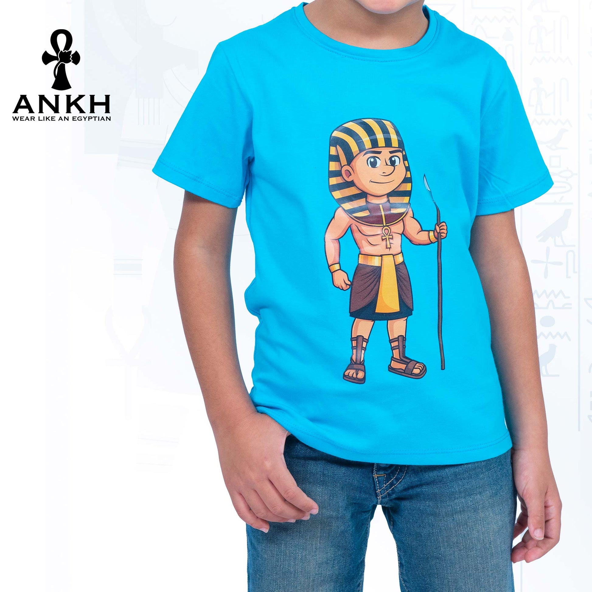 Child wearing a premium white t-shirt adorned with a colorful cartoon depiction of ancient Egyptian King Ahmose, made from luxurious Egyptian Cotton – available exclusively at Ankh