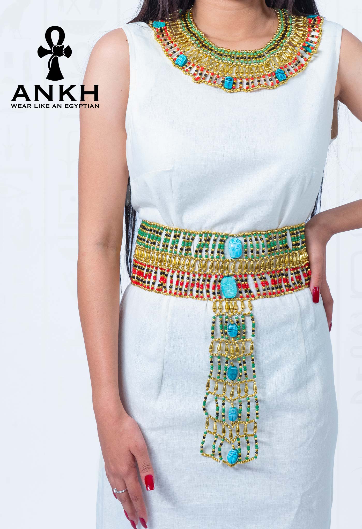 Woman wearing Ankh’s luxurious sleeveless linen dress adorned with iconic red Ankh pendant necklace symbolizing life and immortality